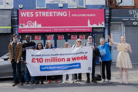 Campaigners at Wes Streeting's office with banner that reads "We lose £10 million a week in private profits from the NHS"