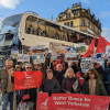 Campaigners at a demonstration to bring buses in West Yorkshire under public control, in front of a bus